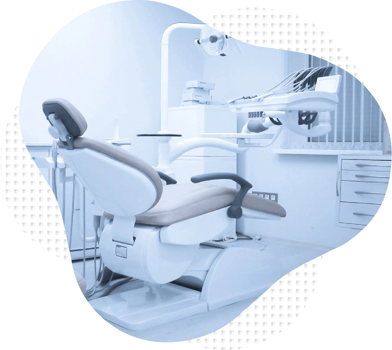 A dentist 's chair in the middle of an office.